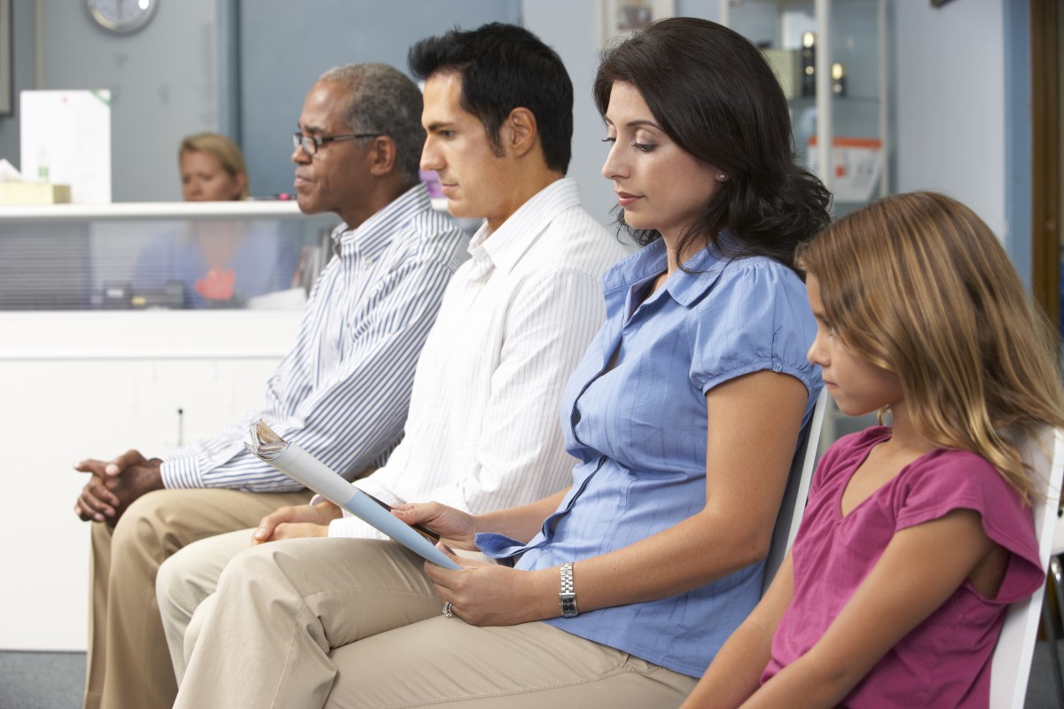 four people sitting in a hospital waiting room