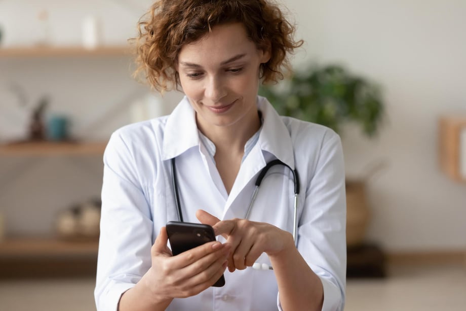 doctor using smartphone to text patients