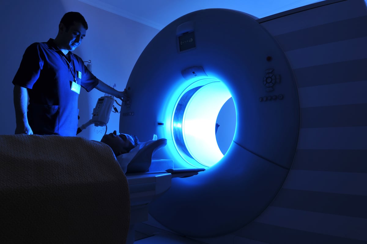 radiation oncologist performing an MRI scan on a patient